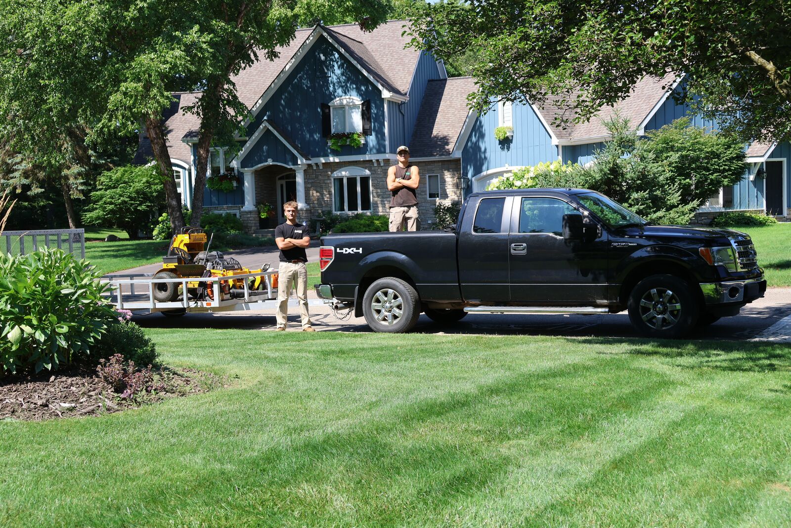 The Overtime Lawncare crew with their truck and equipment trailer